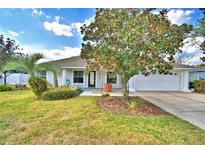 Charming single story home with well-manicured lawn and garden at 105 Shaddock Dr, Auburndale, FL 33823