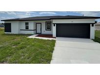 Charming single-story home with a modern color palette and an attached garage at 113 Dogwood Drive Circle, Ocala, FL 34472