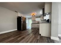 Modern kitchen with stainless steel appliances, white cabinets, and light countertops at 1225 Nemeth St, Auburndale, FL 33823