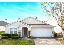 Charming single-story home featuring a well-maintained lawn, inviting entrance, and a convenient two-car garage at 226 Bailey Cir, Davenport, FL 33897