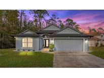 Charming single-Gathering home with a well-manicured lawn, two car garage, and inviting curb appeal at 563 Eagle Pointe S, Kissimmee, FL 34746