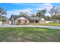 Charming brick home features a well-manicured lawn and a welcoming driveway at 1020 Hobson St, Longwood, FL 32750