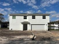 Modern two-story home with a two-car garage and a clean white exterior at 1062 Hidden Dr, Lakeland, FL 33809