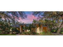 Charming single-story home featuring lush landscaping and unique architectural details at 1672 Wingspan Way, Winter Springs, FL 32708