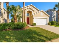 Charming single-Gathering home with a well-manicured lawn, lush landscaping, and an attached two-car garage at 8595 Sunrise Key Dr, Kissimmee, FL 34747