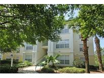 Condominium building featuring lush landscaping, multiple levels and well maintained common areas at 8927 Legacy Ct # 302, Kissimmee, FL 34747