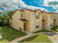 Charming two-story condo with a well-maintained lawn and a classic tiled roof at 8708 Papaya Dr, Kissimmee, FL 34747