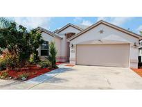 Charming single-story home with a two-car garage and beautifully landscaped front yard at 12634 Ringwood Ave, Orlando, FL 32837