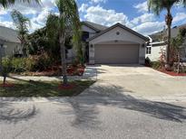 Charming single-story home with a well-manicured lawn and a two-car garage at 12634 Ringwood Ave, Orlando, FL 32837