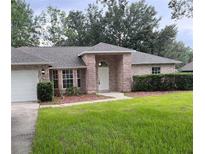 Charming single-story brick home with a well-maintained lawn and mature trees at 3216 Fieldcrest Ter, Deltona, FL 32725