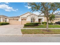 Charming single-story home featuring a well-manicured lawn and a two-car garage at 4911 Drawdy Ct, St Cloud, FL 34772