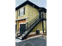 View of the stairs leading to the upper-level entrance, and individual garage parking at 6013 Westgate Dr # 2421, Orlando, FL 32835