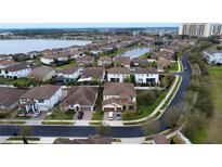 An aerial view of a residential neighborhood with lakeside homes and manicured landscaping at 10902 Citron Oaks Dr, Orlando, FL 32836