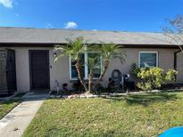 Cozy home featuring desert landscaping, a neutral paint scheme, and updated windows at 113 Las Brisas Way, Kissimmee, FL 34743