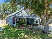 Charming home with a well-maintained lawn, mature trees, and a delightful screened-in porch at 3741 Crossing Creek Blvd, St Cloud, FL 34772