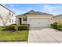 Charming single-story home with a two-car garage and well-maintained landscaping at 444 Lily Ln, Davenport, FL 33837