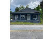 Charming one-story home featuring a cozy porch, a dark roof, and a blue painted exterior at 504 Sw Fort King St, Ocala, FL 34471