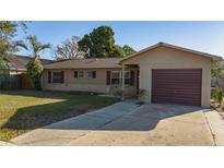 Charming single-story home featuring a well-manicured lawn and a convenient attached garage at 5445 Marvell Ave, Orlando, FL 32839