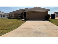 Charming single-story home with a two-car garage and well-maintained landscaping at 553 Viceroy Ct, Kissimmee, FL 34758