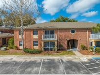 Charming two-story condo featuring a brick facade, balcony, and well-maintained landscaping at 562 Flemming Way # 200, Maitland, FL 32751