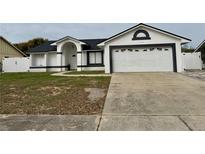 Charming single-story home with a well-manicured lawn and a two-car garage at 7860 Kensingham Ct, Orlando, FL 32835