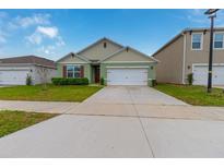 Charming single-Gathering home featuring a two-car garage, manicured lawn, and inviting curb appeal at 1031 August Sky Dr, Deltona, FL 32738