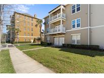 Well-maintained building exterior with multiple balconies and a landscaped lawn area at 1221 Olmstead Blvd # 214, Celebration, FL 34747