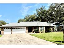 Charming brick home with a well-manicured lawn, two-car garage, and inviting driveway at 3285 Majestic Oak Dr, St Cloud, FL 34771