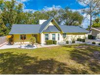 Charming yellow house with a blue roof, well-manicured lawn, and tasteful landscaping at 4318 Oak Ct, St Cloud, FL 34769