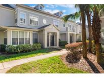 Exterior shot of a townhome showcasing landscaping, an inviting entrance, and architectural details at 5025 Wellington Park Cir # 68, Orlando, FL 32839