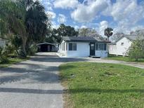 Charming single-story home with a well-maintained front yard, black roof, and driveway at 610 Illinois Ave, St Cloud, FL 34769