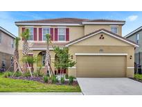 Charming two-story home with a well-manicured lawn, two car garage and a beautiful neutral color scheme at 7622 Oakmoss Loop, Davenport, FL 33837