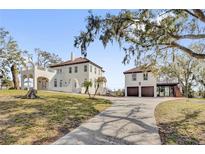 A grand two-story home with a Mediterranean-style roof and a detached garage apartment at 802 S 10Th St, Haines City, FL 33844