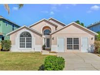 Charming single Gathering home with a well-maintained lawn and a symmetrically designed elevation at 8103 Yellow Crane Dr, Kissimmee, FL 34747