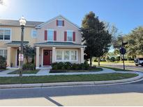 Charming townhome featuring a welcoming porch and lovely landscaping at 10210 Hartford Maroon Rd, Orlando, FL 32827