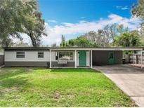 Charming single-story home with a lush green lawn and inviting carport at 3004 Lake Margaret Dr, Orlando, FL 32806