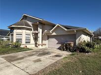 Charming single-Gathering home with a spacious driveway and an attached two-car garage at 414 Otter Creek Dr, Kissimmee, FL 34743