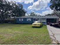 Charming single-story home with a spacious front yard and a long driveway for parking multiple vehicles at 4208 Ridge Rd, Lakeland, FL 33811