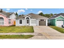 Charming single-story home featuring a well-maintained lawn and driveway at 6921 Long Needle Ct, Orlando, FL 32822