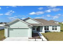 Inviting single-story home with a 2-car garage, well-maintained landscaping, and a charming covered entry at 1116 Caloosa Ridge Way, Babson Park, FL 33827