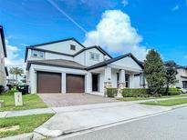 Charming two-story home featuring a two-car garage and beautifully landscaped front yard at 12971 Westside Village Loop, Windermere, FL 34786