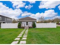 Charming home with a well-manicured lawn, stepping stone path, and a white picket fence at 2286 Sunny St, Kissimmee, FL 34741