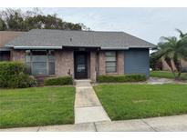 Charming single-story home with brick and siding exterior, manicured lawn, and mature palm tree at 2650 King Oak Cir, St Cloud, FL 34769