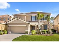 Charming two-story home featuring a tile roof, well-manicured lawn and two-car garage at 5117 Oakbourne Ave, Davenport, FL 33837