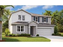 Charming two-story home featuring a two-car garage, landscaped yard, and gray color palette at 5457 Catmint Dr, Lake Hamilton, FL 33851