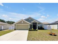 Charming single-story home with well-maintained lawn and a two-car garage at 1238 James Ln, Kissimmee, FL 34759