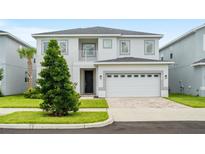 Charming two-story home with landscaped yard and a two car garage at 194 Golden Noble St, Davenport, FL 33897