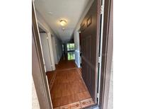 Hallway features beautiful tile flooring and a view of the bright, airy living spaces at 2900 S Semoran Blvd # S, Orlando, FL 32822