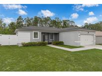 Charming single-story home with a well-manicured lawn, neutral paint, and screened entry at 33 Perch Dr, Kissimmee, FL 34759