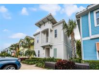 Charming two-story home with a balcony and landscaped yard, perfect for enjoying the coastal lifestyle at 8012 Lost Shaker Ln, Kissimmee, FL 34747